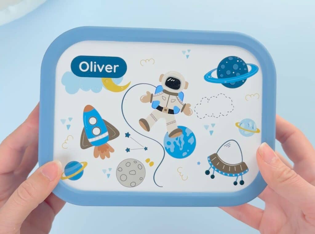 blå matboks med astronaut-design og teksten Oliver